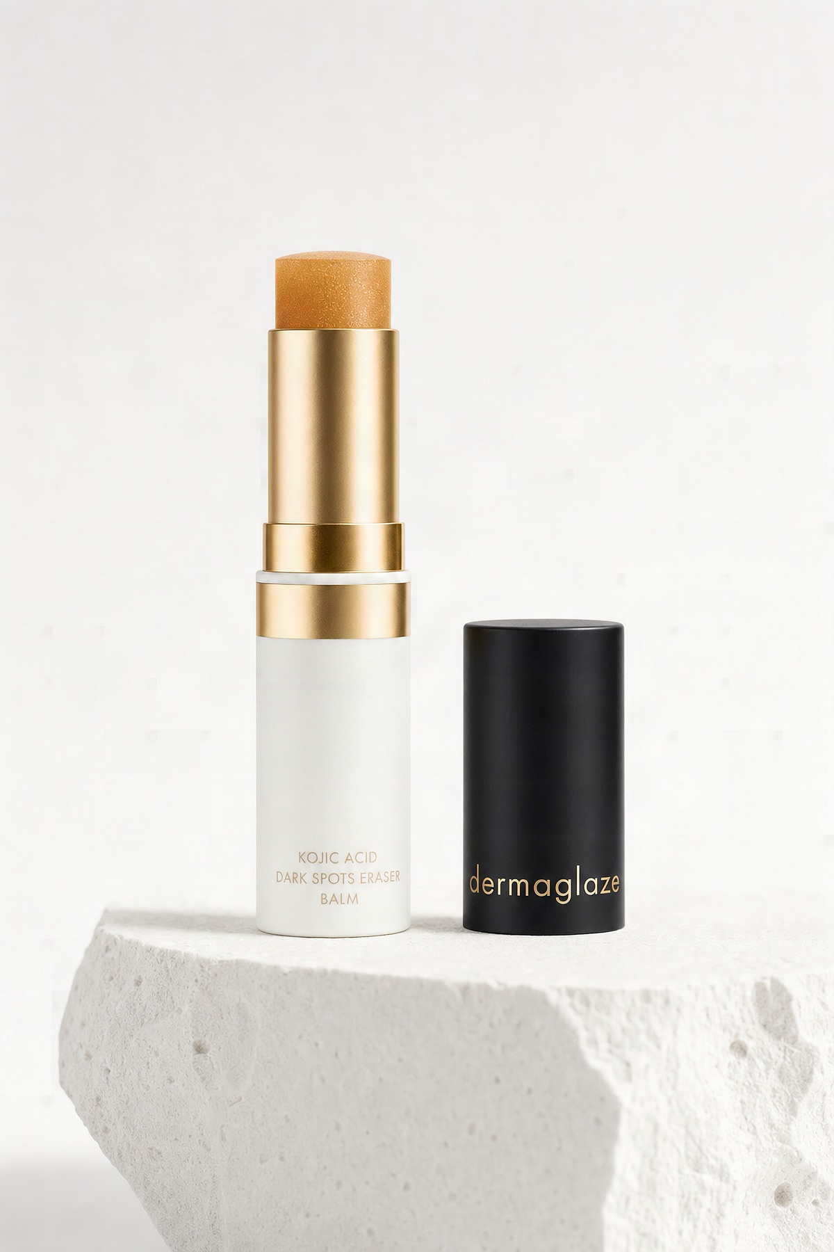 Balm with cap off, amber bullet raised